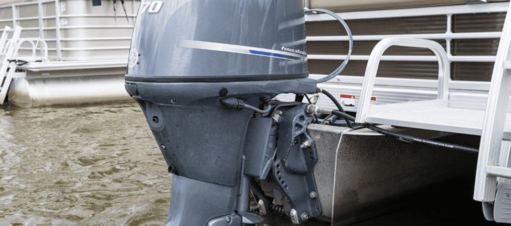 Close-up view of a boat motor lower unit submerged in water.