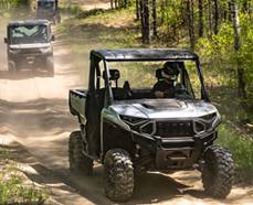 ATV/UTV going down a trail in the forest