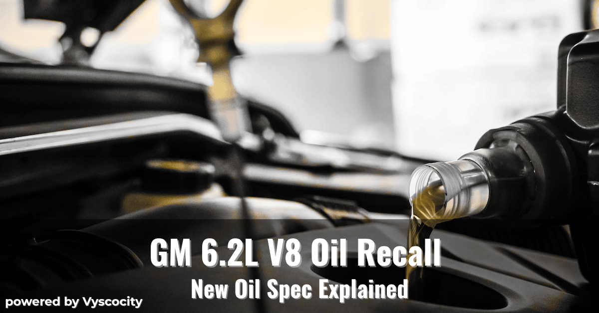Close-up of motor oil being poured into a GM 6.2L V8 engine with overlay text about an oil recall and new specification update.