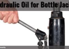 Hand operating a bottle jack with a metal handle — used for applying hydraulic oil. Vyscocity branding.